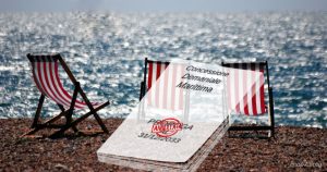 Sdraio sulla spiaggia con un documento trasparente che annuncia l'annullamento della proroga delle concessioni demaniali marittime al 31/12/2033